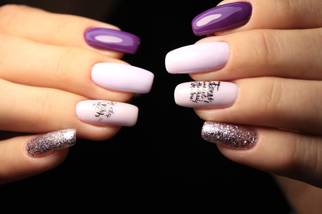 Stylish gel polish in purple, pink and glitter