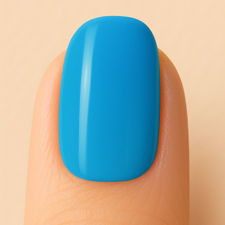 Blue Gel polish on a finger against a beige background