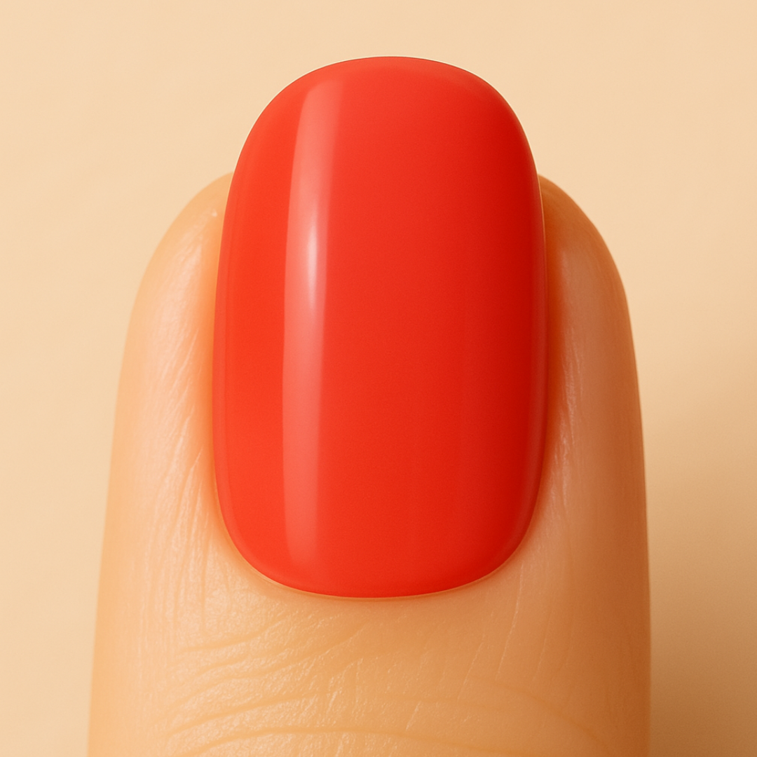 Close-up of a red gel polish on a beige background