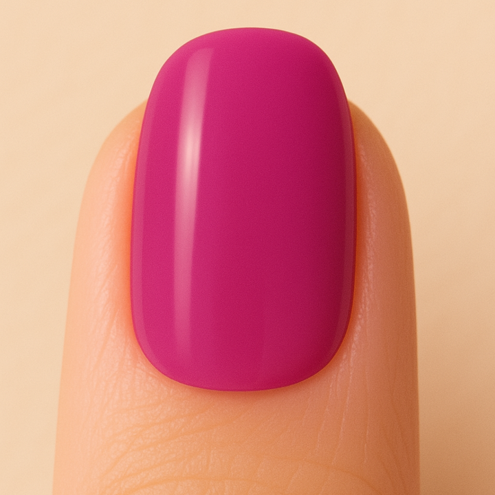 Finger with a bright pink nail on a beige background