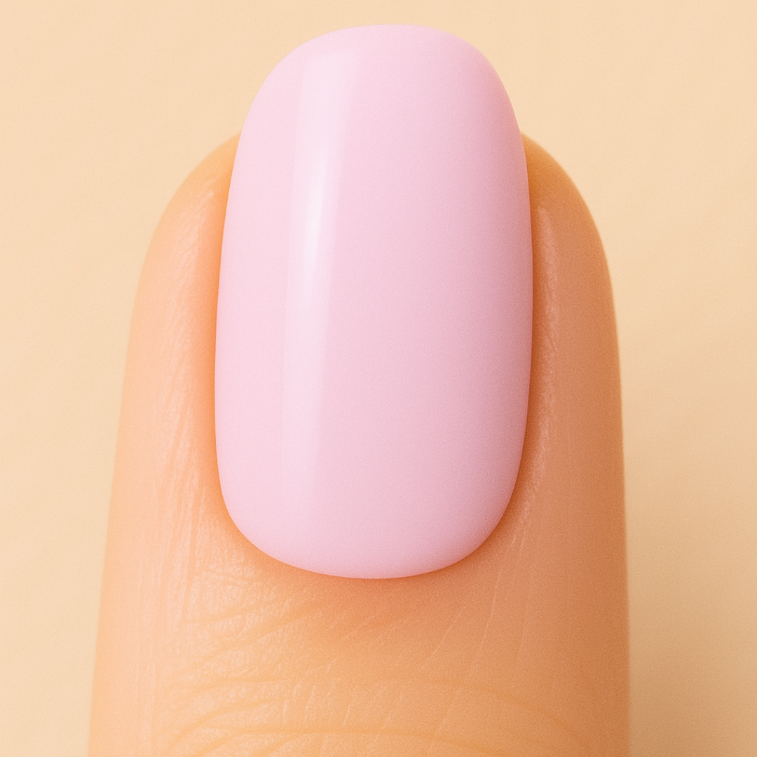 Close-up of a pink nail on a beige background
