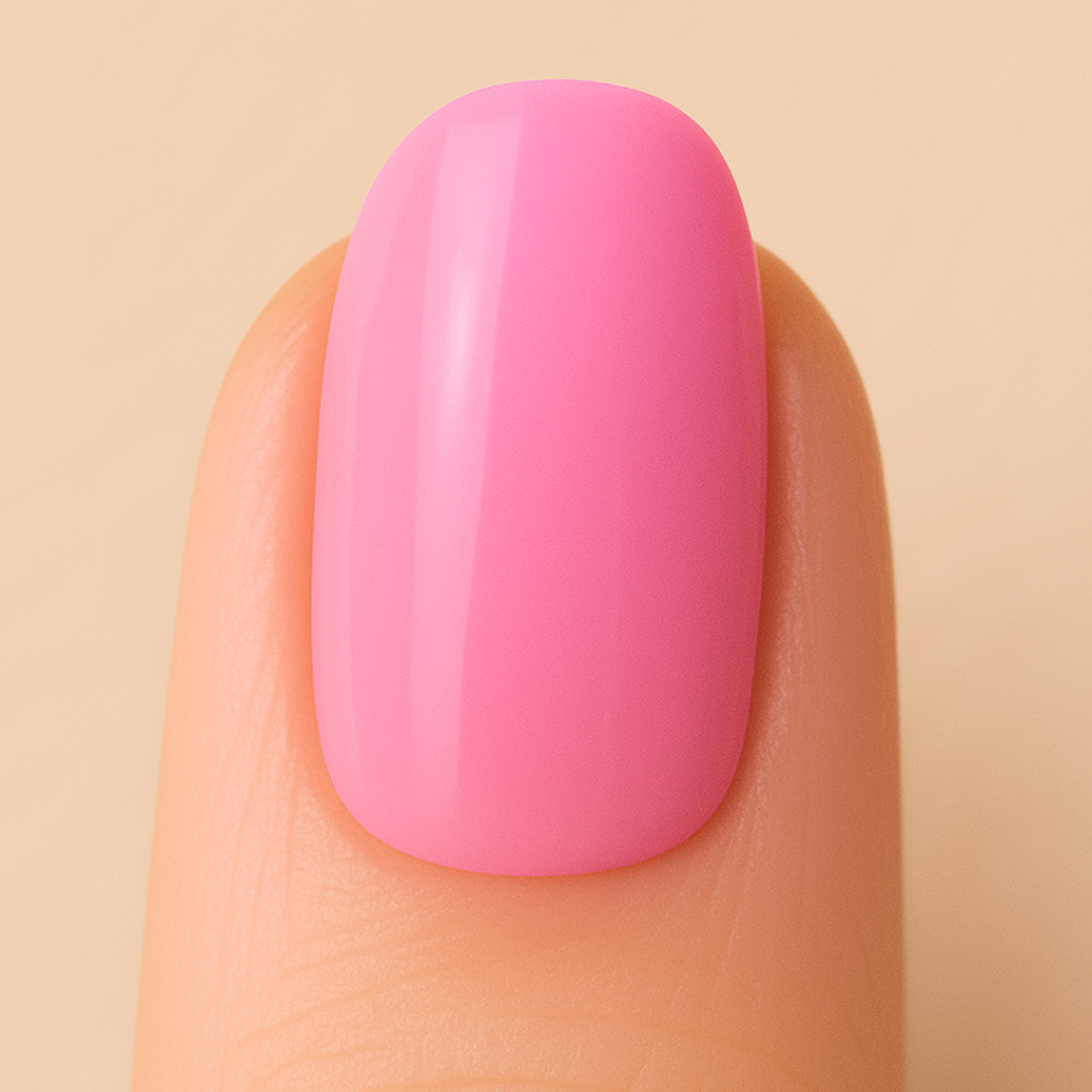 Close-up of a pink nail on a beige background