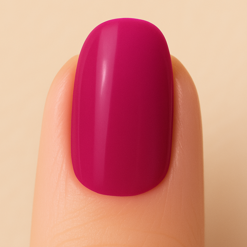 Finger with a bright pink nail on a beige background