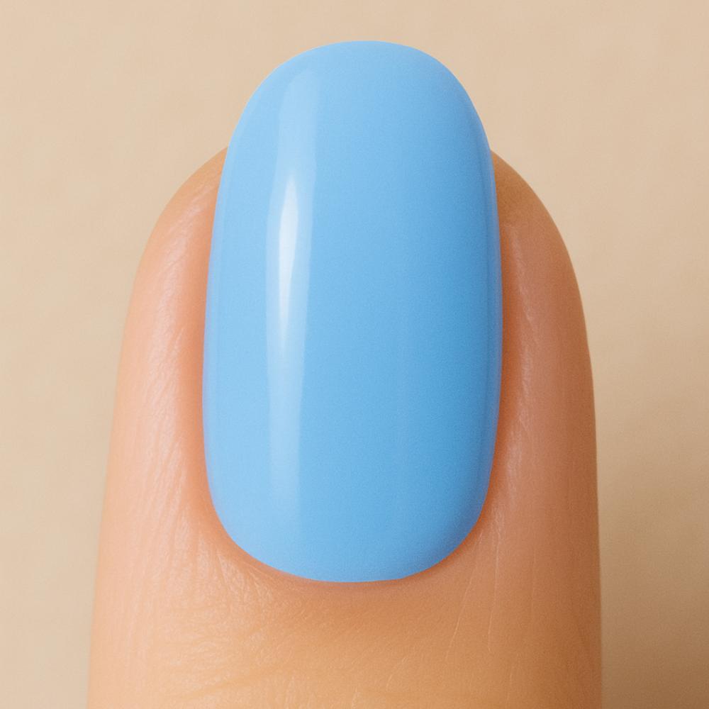 Light blue gel nail polish on a finger against a beige background