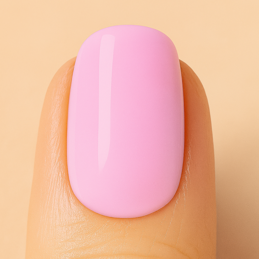 Close-up of a pink nail on a beige background