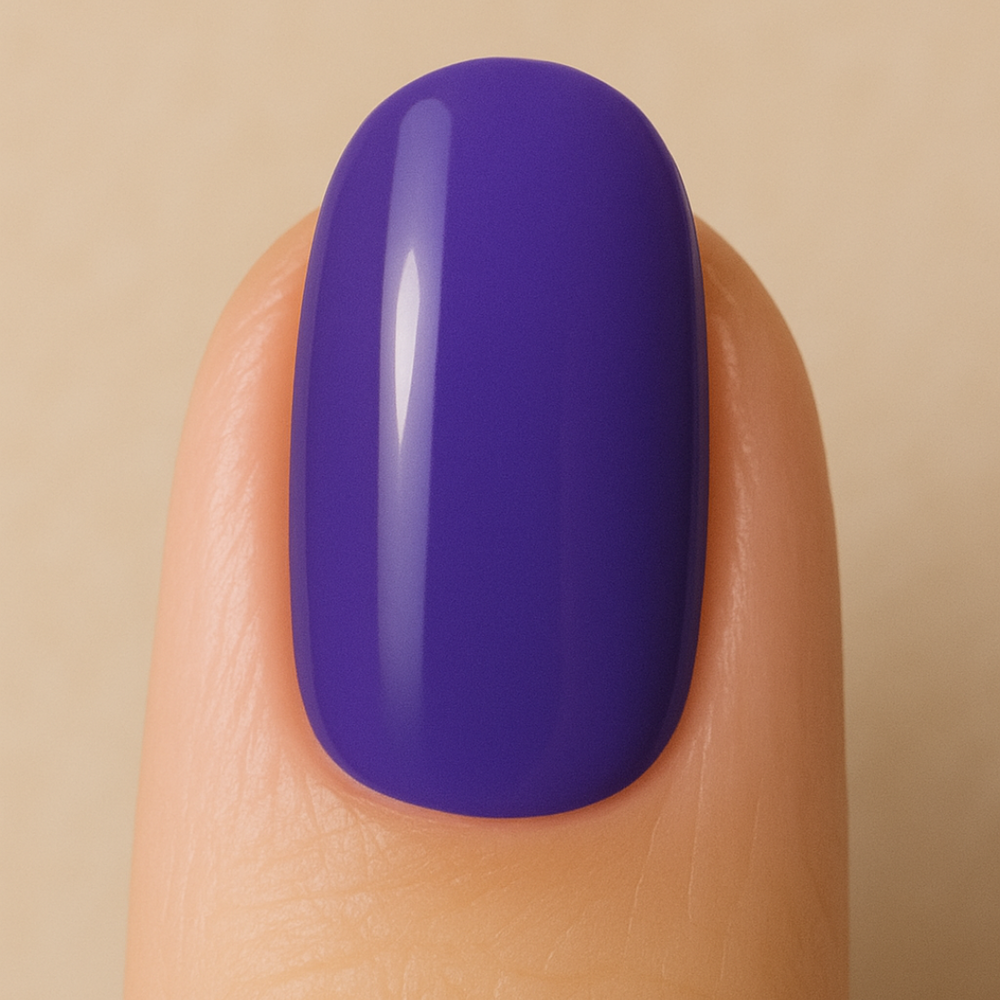 Nail with purple gel polish on a beige background