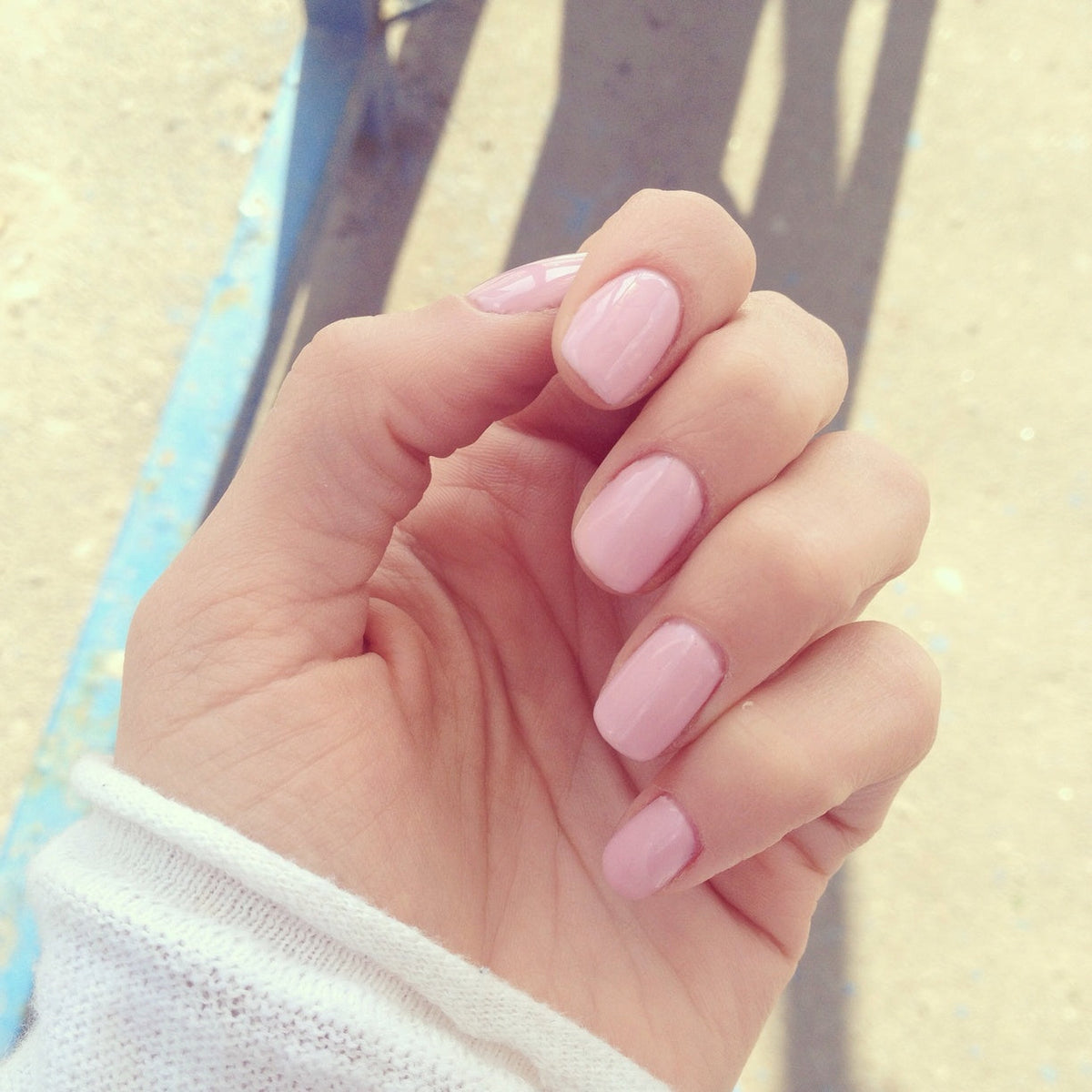 manicured nails coloured with pink polish