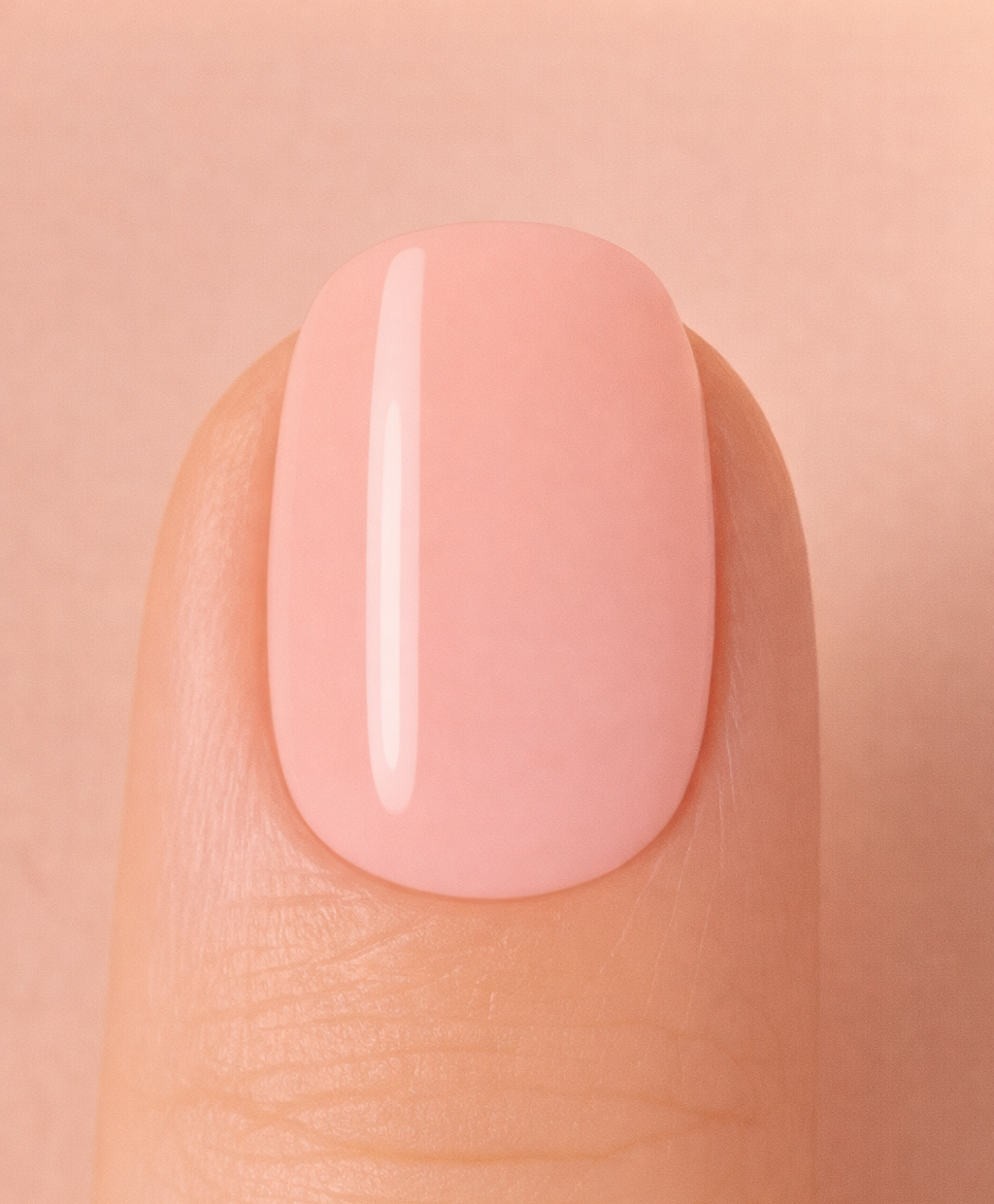 Close-up of a pink nail on a beige background