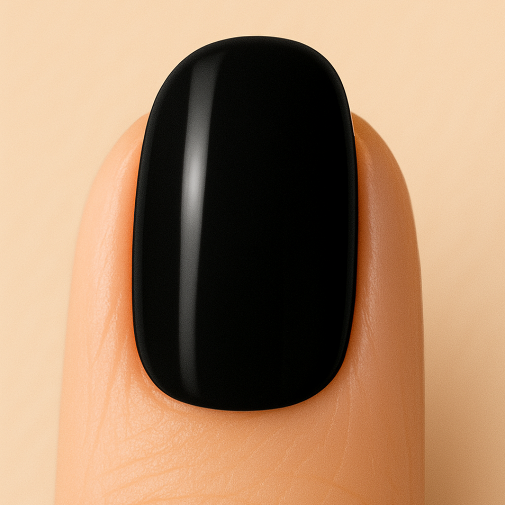Black gel nail polish on a finger against a beige background