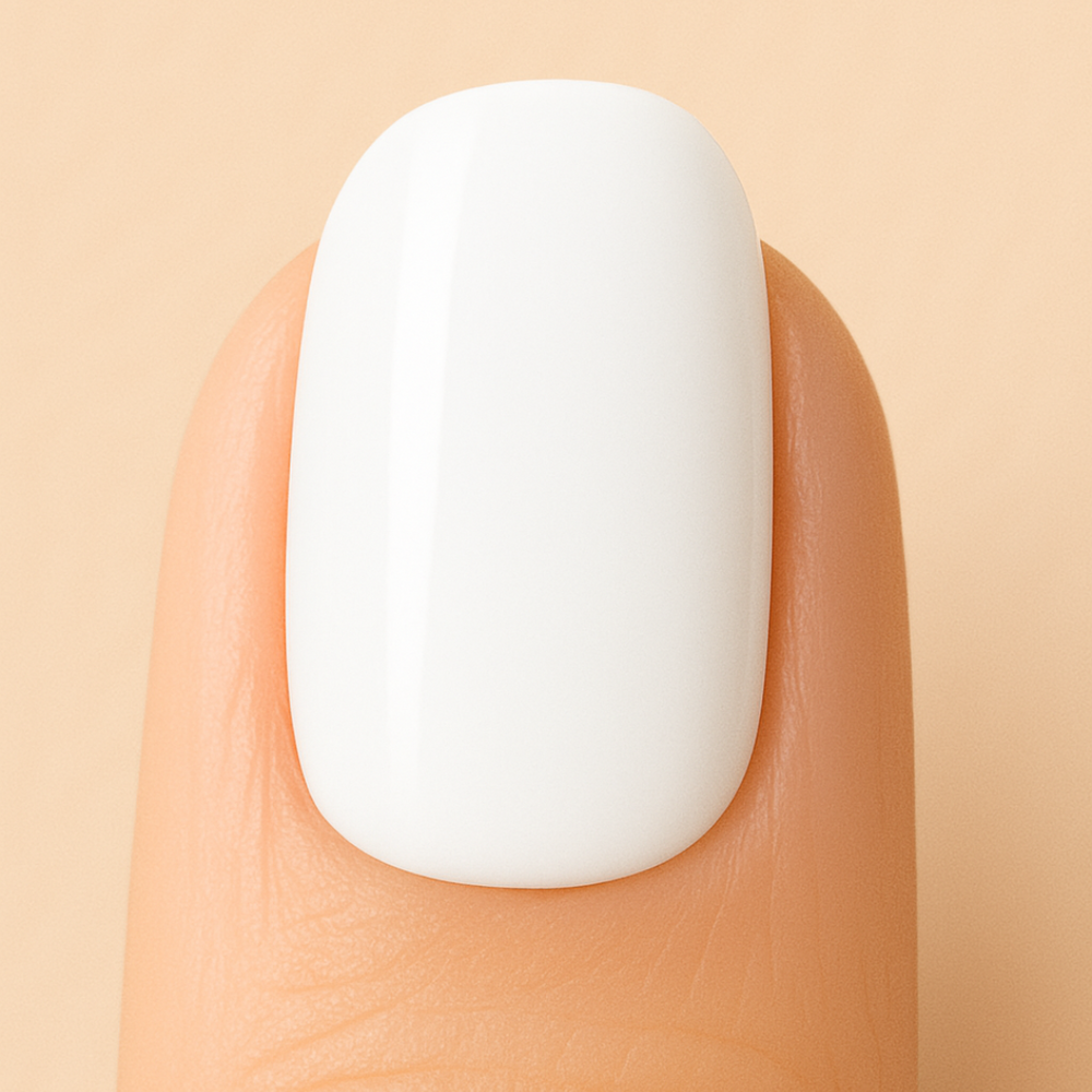 White Gel polish on a nail against a beige background
