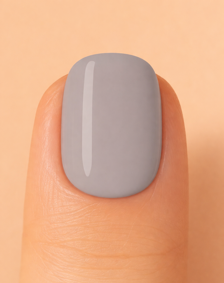 Grey colour nail on beige background