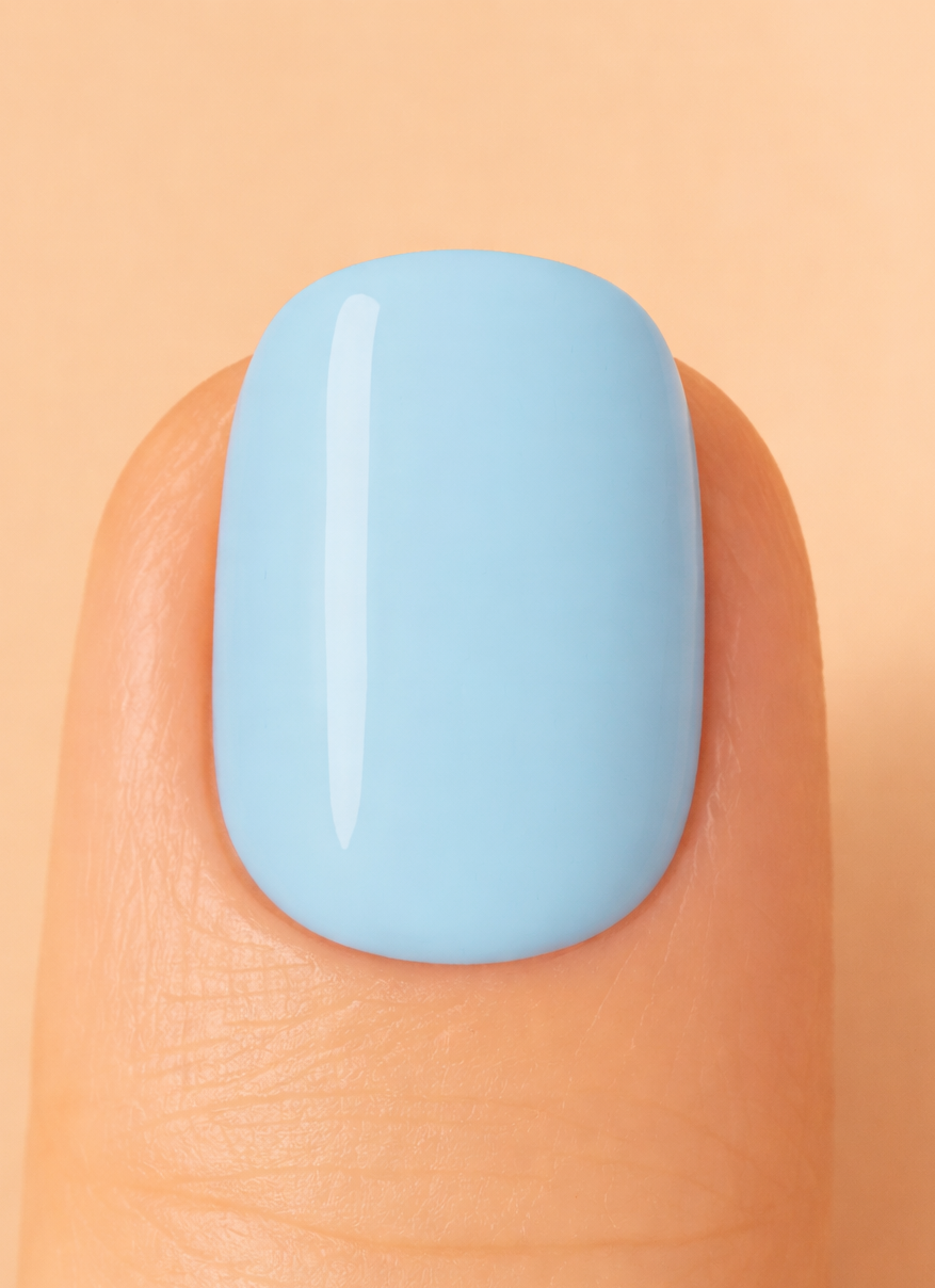 Light blue nail polish on a finger against a beige background