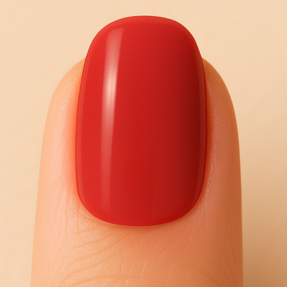 Red gel nail polish on a finger against a beige background