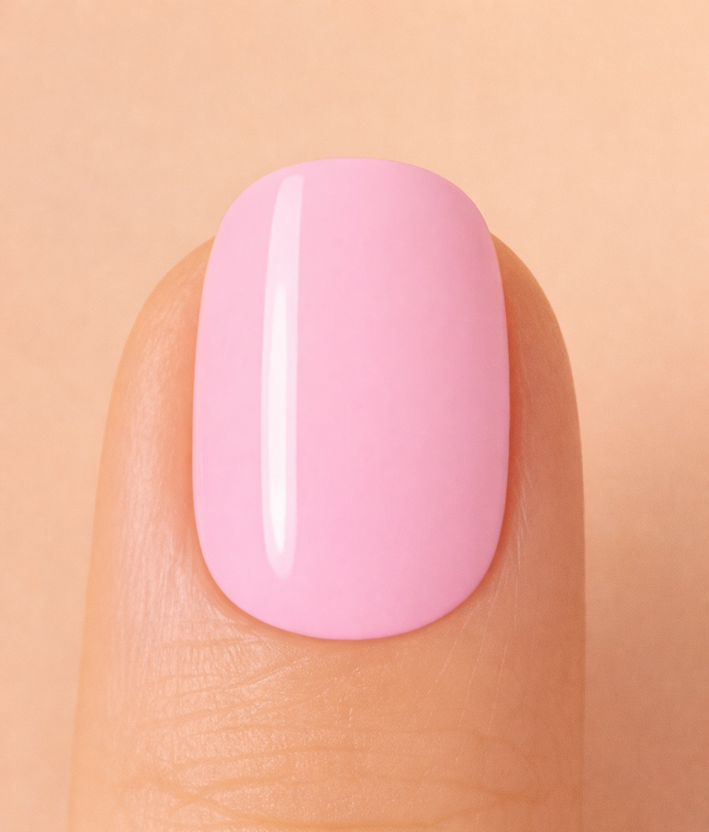 Close-up of a pink nail on a beige background