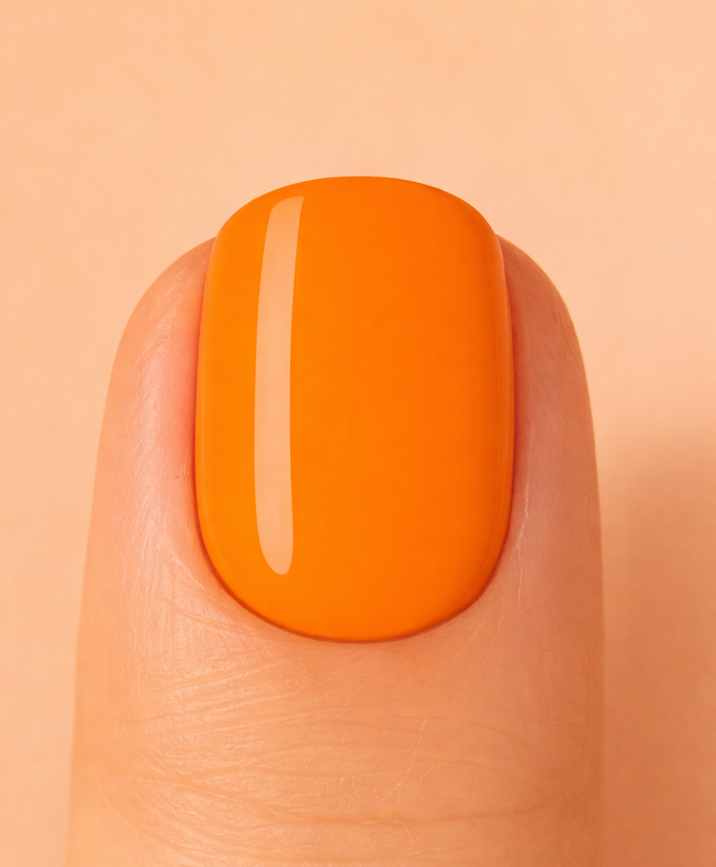 Orange nail polish on a finger against a beige background